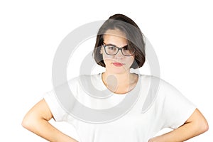 Studio photo of a beautiful serious girl in glasses with her hands on her waist on a white background