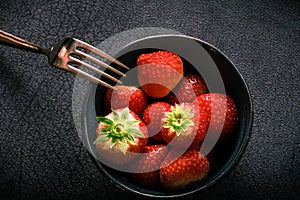 Studio photo of a bowl with strawberries