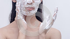 A studio photo of a foamy facial wash applied on the face. Mild facial cleanser for dry and sensitive skin type.