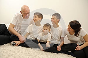 Studio photo shoot group portrait of cheerful big extended multi generational family against grey background Happy