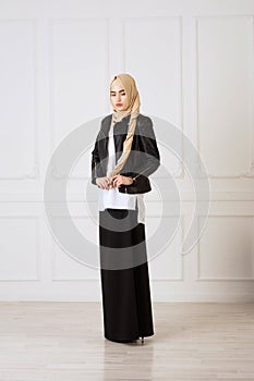 Studio photo of a young woman eastern type of clothing that combines modern and Muslim style, and a beautiful headdress