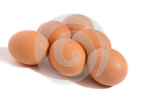 A studio photograph of half a dozen hen`s eggs