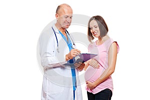 Studio picture of pregnant woman and doctor