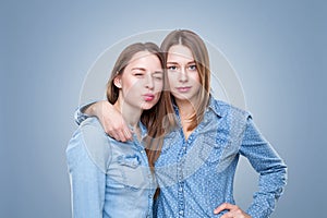 Studio portait of young twin sisters embracing
