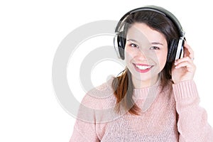 Studio portrait of adorable happy smiling young woman relaxing in headphones