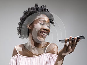Studio portrait of african-american woman with vitiligo skin, beauty concept