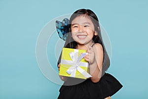 Studio portrait of asian girl happily receiving a gift