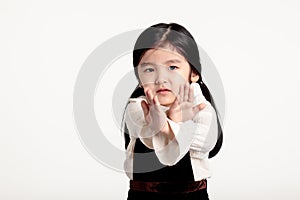 Studio portrait of an asian girl rejecting something