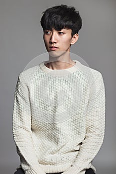 Studio portrait of an asian man with an expressionless look