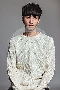 Studio portrait of an asian man with an expressionless look photo