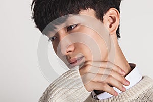 A studio portrait of an Asian man reminiscent of something faintly