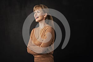 Studio portrait of an attractive middle age woman against dark background