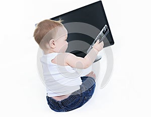 Studio portrait of a baby boy holding a tv remote