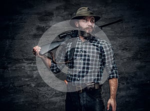 A hunter holds a rifle.