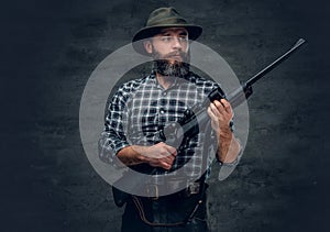 A hunter holds a rifle. photo