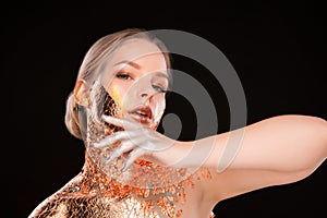 Studio portrait of beautiful blonde woman with golden glow foil
