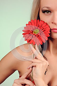 Studio portrait of beautiful sexy girl  with  big red flower