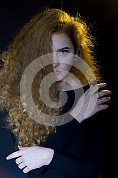 Studio portrait of beautiful young model on black background