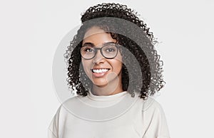 Studio portrait of a beautiful young woman with black curly hair. African american student girl close up isolated portrait