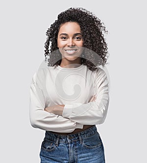 Studio portrait of a beautiful young woman with black curly hair. African american student girl close up isolated on white backgro