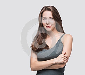 Studio portrait of a beautiful young woman with brown hair. Pretty model girl with perfect fresh clean skin