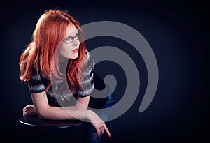 Studio portrait of the beautiful young woman with ginger hair