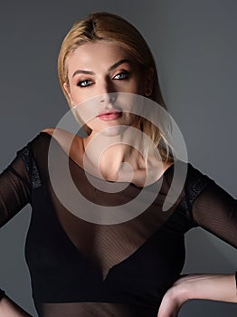 Studio portrait of a beautiful young woman. Pretty model girl with perfect fresh clean skin. Beauty, wellness. Fashion