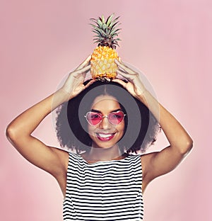 Studio, portrait and black woman with pineapple, diet and detox on pink background. Eyewear, nutrition and gut digestion