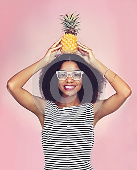 Studio, portrait and black woman with pineapple, diet and detox on pink background. Health, nutrition and gut digestion