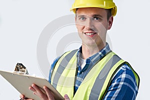 Studio Portrait Of Builder Architect With Clipboard Against White Background