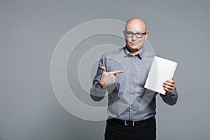 Studio portrait of business trainer holding the white book