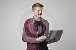 Studio Portrait Of Casually Dressed Businessman With Laptop