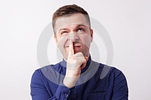 Studio portrait caucasian man finger in nose