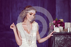 Studio portrait of cheerful bride with perfect hairstyle and makeup.