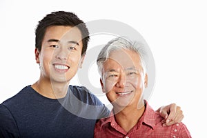 Studio Portrait Of Chinese Father With Adult Son