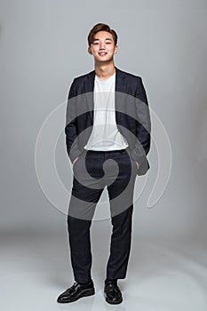 Studio portrait of a confident young East Asian business man