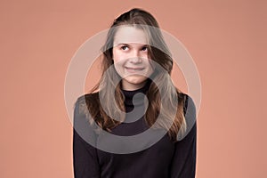 Studio portrait of a cunning girl looking aside