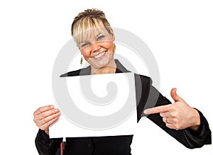 Studio portrait of a cute blond girl holding a piece of paper