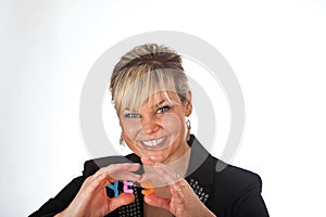 Studio portrait of a cute blond girl holding two letters forming