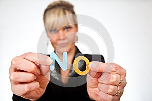 Studio portrait of a cute blond girl holding two letters forming