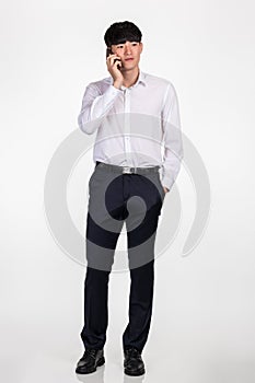 A studio portrait of an East AsiaaA studio portrait of an Ean business man pointing at something and posing for a variety of poses
