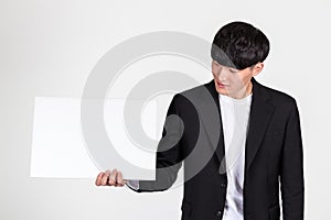 Studio portrait of an East Asian business man doing various pose with whiteboard