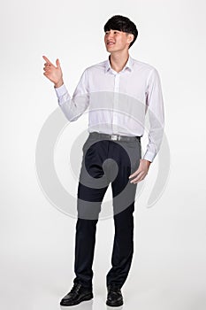 A studio portrait of an East Asian business man pointing at something and posing for a variety of poses