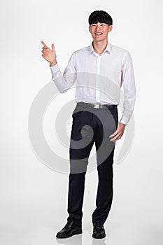 A studio portrait of an East Asian business man pointing at something and posing for a variety of poses