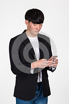 A studio portrait of an East Asian business man posing for various poses with a cellphone