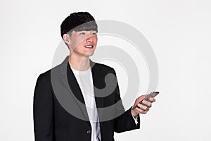 A studio portrait of an East Asian business man posing for various poses with a cellphone