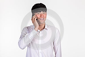 A studio portrait of an East Asian business man posing for various poses with a cellphone