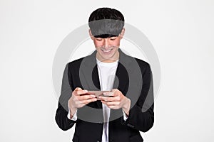 A studio portrait of an East Asian business man posing for various poses with a cellphone