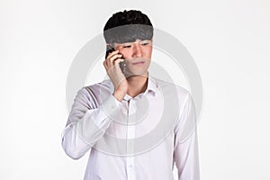 A studio portrait of an East Asian business man posing for various poses with a cellphone