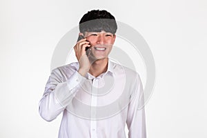 A studio portrait of an East Asian business man posing for various poses with a cellphone